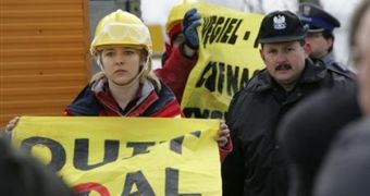 Greenpeace protesters wave a "Quit Coal" banner, near the open-pit Jozwin mine, in Poznan, Poland