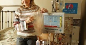 Calgarian Didja Nawolsky sets up a dialysis machine at her home Thursday. She spends five hours a day hooked up to the unit that cleanses her blood.