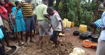 Kids help build eco-friendly stoves in Uganda