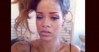 Rihanna reacts to fan grabbing her hand during a concert