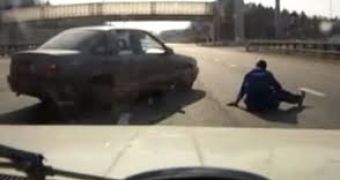 A motorcyclist crashes in Russia as a driver is telling his daughters about dangers she faces in traffic
