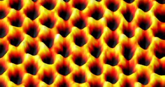 This image of a single suspended sheet of graphene shows individual carbon atoms (yellow) on the honeycomb lattice