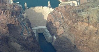 Hoover Dam, a concrete arch-gravity dam in Black Canyon of the Colorado River. Lake Mead in the background is impounded by the dam.