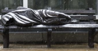 A sculpture of homeless Jesus lies on a bench in Toronto