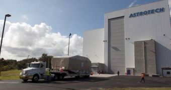 A truck hauls NASA's TDRS-L satellite to the Astrotech facility in Titusville for launch processing, after the spacecraft was delivered to the KSC on December 6, 2013