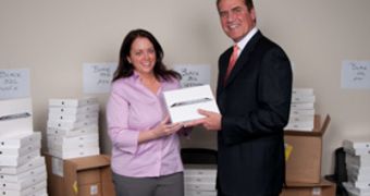 Henry S. Givray, president and CEO, presents the first iPad 2 to Ellen Brislin, corporate controller