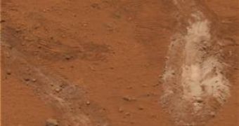 The bright patch of Martian soil churned up by a bum wheel on NASA's Spirit rover turns out to be 90 percent pure silica ? a material that would have required water to produce, scientists say.
