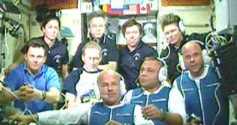 The nine astronauts currently aboard the ISS, during a greeting conference they held today, after TMA-16 docked on the space lab