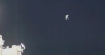 An unidentified object - potentially a cable attachment fixture - floats away from two Russian cosmonauts conducting a spacewalk July 27 outside the International Space Station