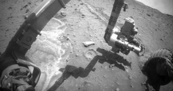 Spirit is seen here stretching out its robotic arm, during the latest maneuvers on the surface of Mars