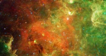 This swirling landscape of stars is known as the North American nebula. In visible light, the region resembles North America, but in this new infrared view from Spitzer, the continent disappears