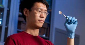 Yuan Yang, a graduate student in Materials Science, holds one of the transparent batteries he developed with Professor Yi Cui