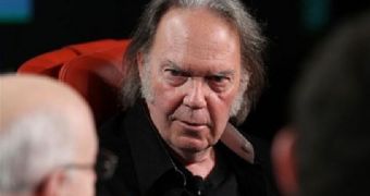 Neil Young, a Canadian singer and songwriter who is widely regarded as one of the most influential musicians of his generation