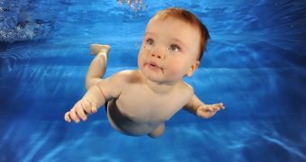 Baby swims alone in a pool