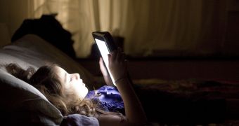 Girl using iPad in bed
