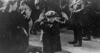 Picture of a boy in Warsaw, 1943. Pointing the gun, mass murderer Josef Blösche, executed in 1969
