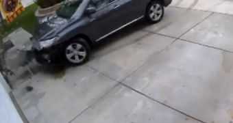 A Toyota Highlander crashes into a garage door twice