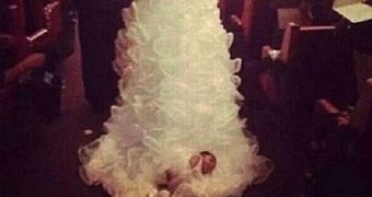 Woman drags her newborn daughter on her wedding dress while walking down the aisle