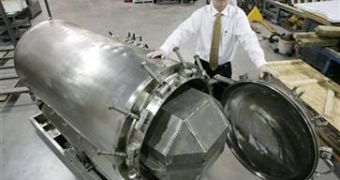 Brad Crain, president of BioSafe Engineering, near one of the steel cylinders used for alkaline hydrolysis