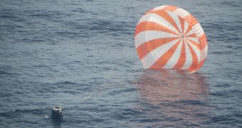 The Dragon capsule parachuting down to Earth