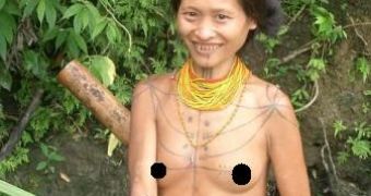 Siberut woman fishing. Notice the cut teeth and the tattoos