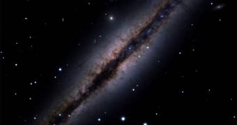 Image of NGC 891, an edge-on galaxy partially obscured by the interstellar dust in the galactic disc
