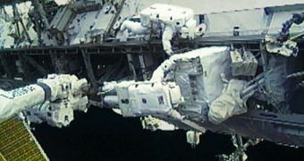 Doug Wheelock is attached to Canadarm2 as he removes the failed 780-pound ammonia pump module. Tracy Caldwell Dyson assists him from the S1 Truss during an EVA on August 11