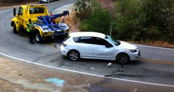 Tow Truck Driver Fails to Secure Car, Has It Roll Off the Road