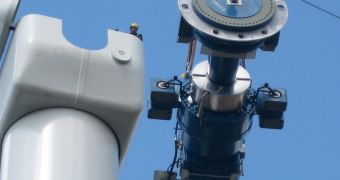 Components of a horizontal axis wind turbine (gearbox, rotor shaft and brake assembly) being lifted into position