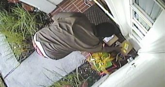UPS employee grabbing FedEx box