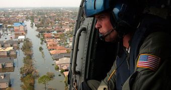 US Coast Guard Petty Officer 2nd Class Shawn Beaty looks for survivors over New Orleans, in the wake of Hurricane Katrina