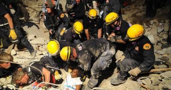 Rescue workers pull a survivor from under concrete blocks, in the Haitian capital Port-au-Prince