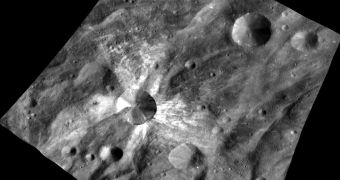 The Canuleia crater on the Vesta protoplanet/asteroid. Notice the fresh, white material dug up by the impact