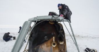 Soyuz TMA-10M is seen here while Russian engineers unload experiments, on March 11, 2014