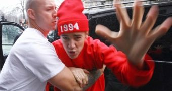 Justin Bieber being restrained by his bodyguard as he attempted to pick a fight with a British paparazzo some time ago