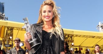 Demi Lovato proudly shows off her Moonman, which she got for Best Video with a Message