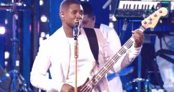 Usher jams on a guitar during performance of “She Came to Give It to You” at the VMAs 2014