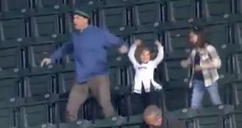 A stadium camera captures footage of a family dancing