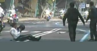 Motorcycle riding policeman hits a speed bump