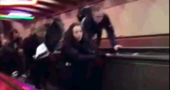 People try to grab on as escalator goes in reverse