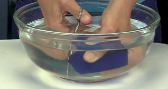 Video shows woman cutting glass with a pair of scissors