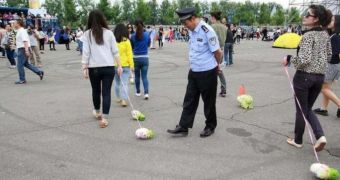 Teenagers in China walk cabbages in leashes