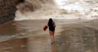 The young woman decides to dance instead of getting out of the wave's course