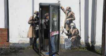 The mural depicts three man spying on a telephone booth