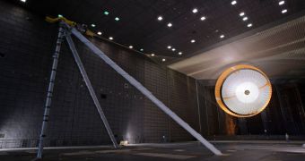 This image shows Curiosity's parachute being tested in a massive wind tunnel. See the human for scale