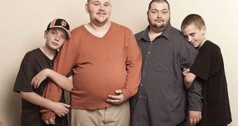 Heavily pregnant Scott Moore with husband Thomas and their two children
