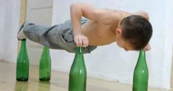 Giuliano Stroe does push-ups while balancing on glass bottles: he's just 7 years old
