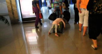 Girl sleeps on luggage in terminal