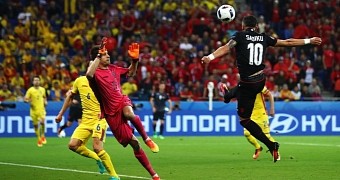 Albanian player scoring winning goal against Romania