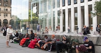 Customers waiting in line in front of Apple Store